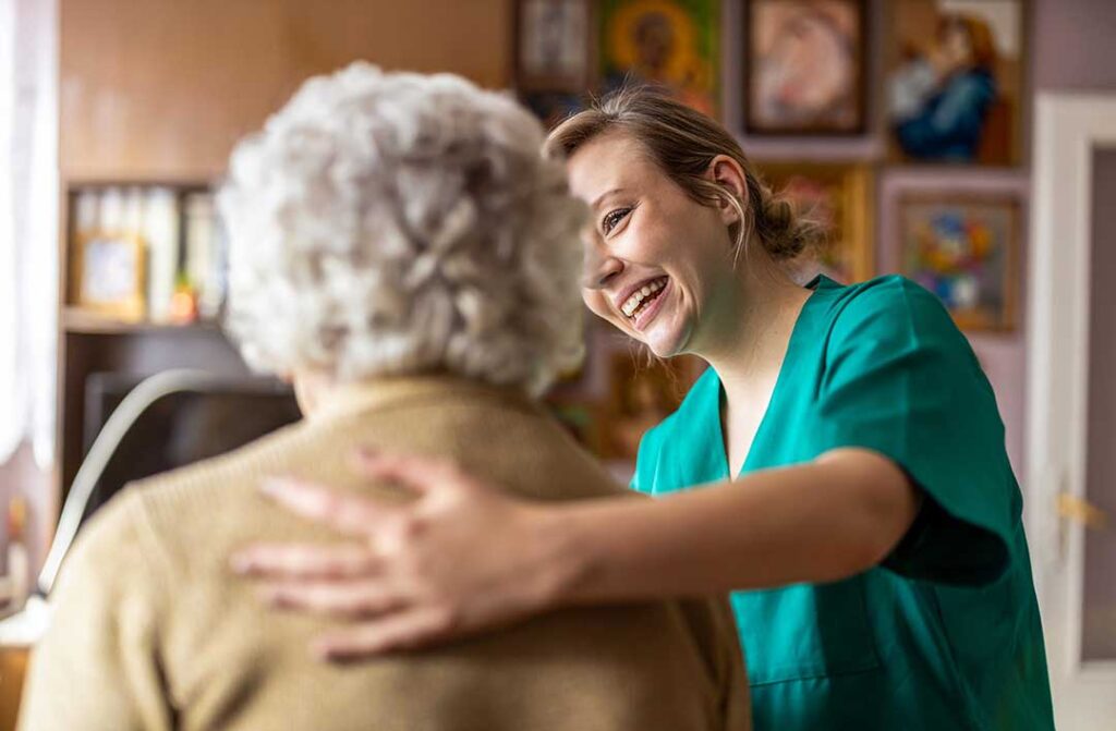 Seniors chatting and engaging in a cozy community living room with personal decorations and natural light.