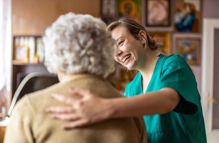 Seniors chatting and engaging in a cozy community living room with personal decorations and natural light.