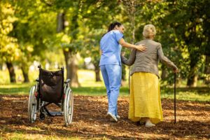 Older adult and family member reviewing home care and assisted living expenses at a kitchen table.