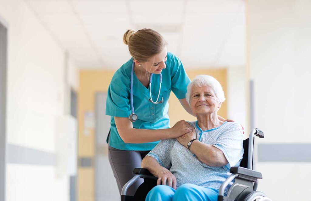 Caregiver and older resident review a personalized care plan at a table with notes and medication details.